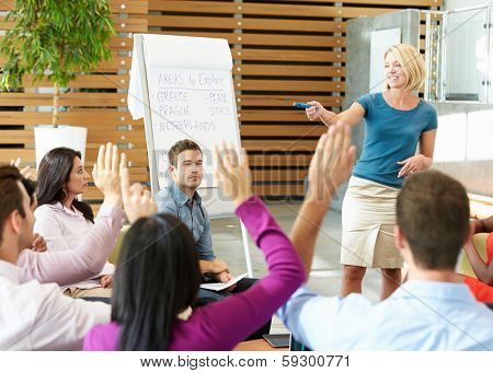 Businesswoman Making Presentation To Office Colleagues
