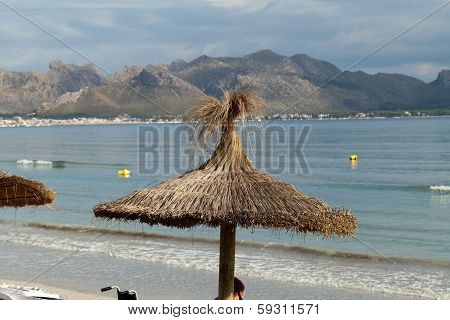 Cane beach umbrella in Pollenca Port. Majorca Spain