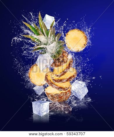 Sliced Pineapple In Water Splashes With Ice Cubes