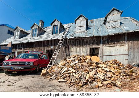 ZABLJAK, MONTENEGRO - AUG 17, 2012: Pile of wood in front of the old wooden house in Zabljak, Montenegro on August 17, 2012. Zabljak is the city on the highest altitude of the Balkans.