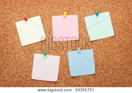 Blank postit notes on cork wood notice board