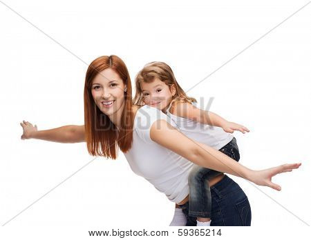 childhood and parenting concept - happy mother and child doing piggy back