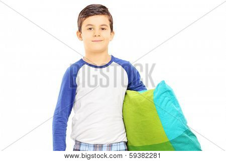 Boy in pajamas holding a pillow isolated on white background