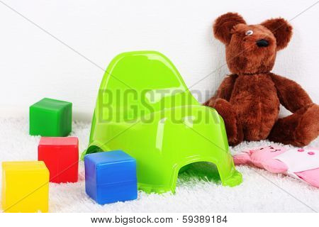 Green potty on home interior background