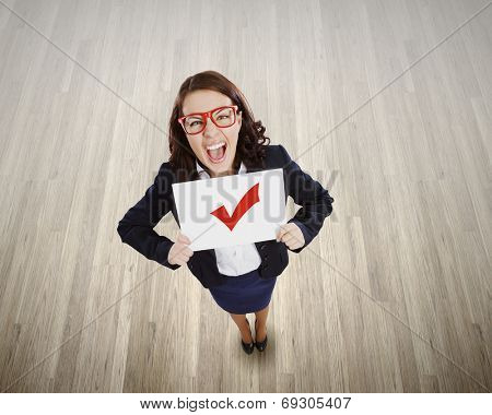 Top view of businesswoman holding white banner with red tick