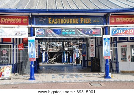EASTBOURNE, ENGLAND - JULY 31, 2014: The historic Victorian pier after being badly damaged by fire on July 30, 2014. Designed by Eugenius Birch, the pier opened in 1870.