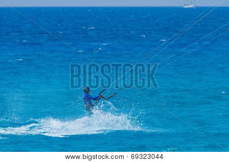 young kiter in the surrounding of turquoise sea kiting in Lefkas Greece