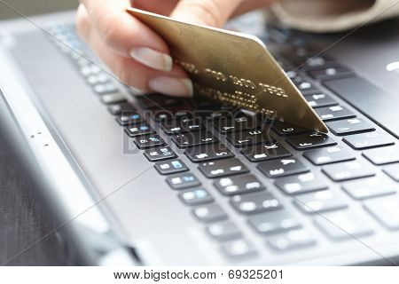woman holding credit card on laptop for online shopping concep