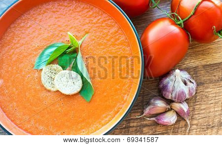 Bowl of tomato soup gaspacho with basil and crackers