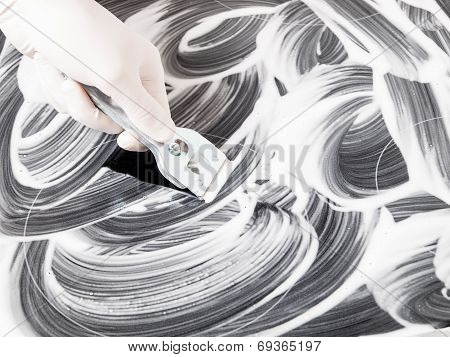 Hand Cleaning A Vitroceramic With A Scraper