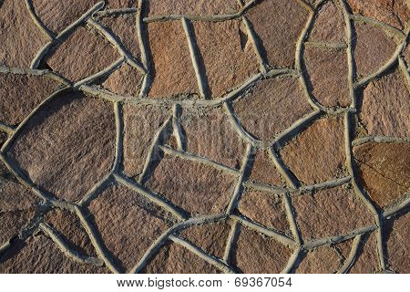 A wall covered with tiles of irregular form