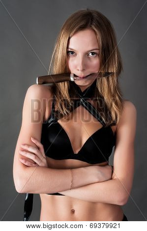 Pretty girl holds knife in teeth