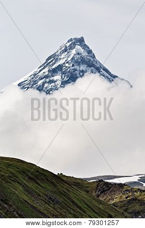 Mountain Landscape Of Kamchatka: Kamen Volcano In Clouds