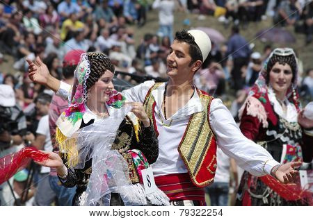 LEPUSHE, ALBANIA - AUGUST 11: a young couple in albanian costume performs a courtship dance. The beautiful girl is the winner of 