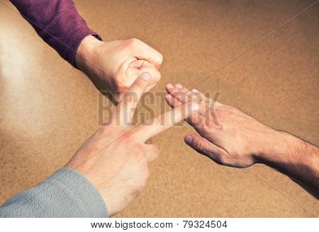 Hands playing paper rock scissors