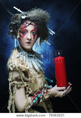 Young woman with creative make up. Halloween theme. Zombie theme.
