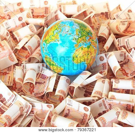 Globe against five thousandth Russian banknotes