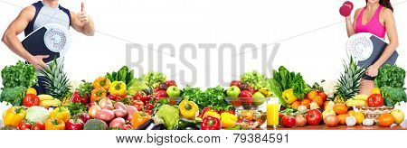 Woman with scales fruits and vegetables background