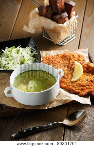 Chicken broth with egg, fried meat in batte