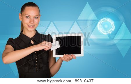 Businesswoman holging tablet and card