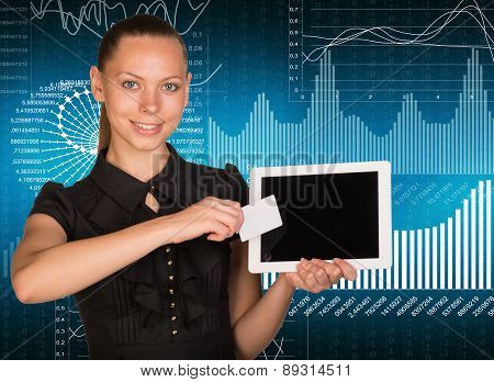 Young woman holging tablet and card