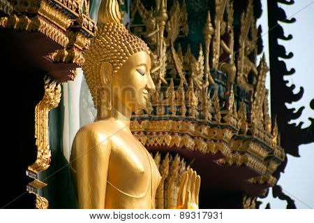 Standing Buddha Front Of Church On Thai Temple In Thailand.
