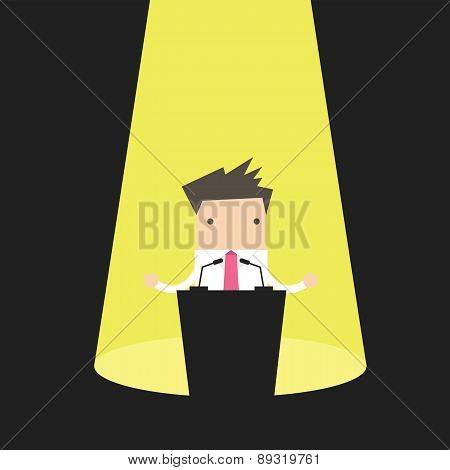 Businessman behind a podium with microphones. Speaker makes a report to the public