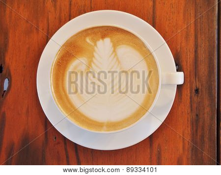 Latte Coffee art on the wooden desk.