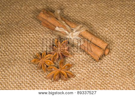 Star Anise And Cinnamon Sticks On Old Cloth