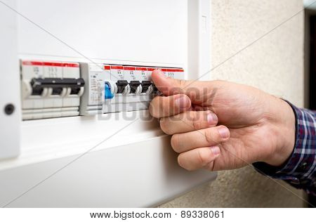 Closeup Of Man Switching On Fuseboard