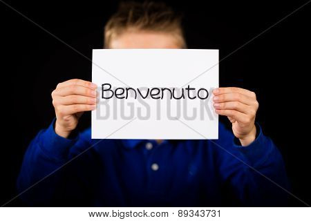 Child Holding Sign With Italian Word Benvenuto - Welcome