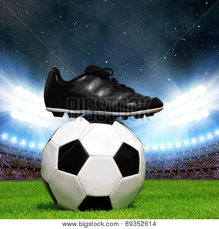 Soccer ball and shoes in grass