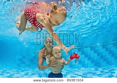 Baby Underwater Swimming Lesson With Instructor In The Pool