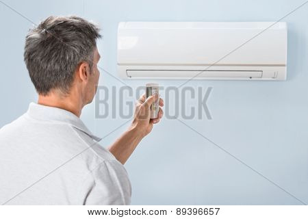 Man Using Air Conditioner Remote