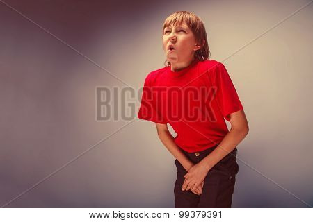 boy teenager European appearance in a red shirt holding hands in