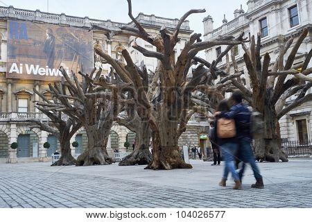 LONDON, UK - SEPTEMBER 23: Visitors appreciating Ai Wei Wei's installation 'Tree' in the forecourt of the Royal Academy of Arts. September 23, 2015 in London.