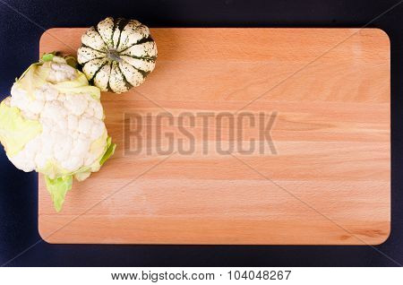 Organic cauliflower and pumpkin on wooden background