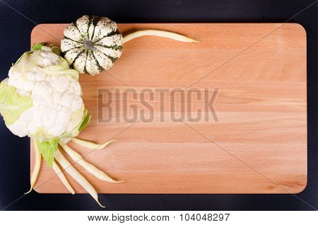 Organic  cauliflower, pumpkin and beans on wooden background