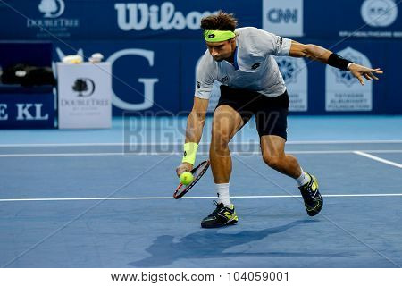 KUALA LUMPUR, MALAYSIA - OCTOBER 01, 2015: David Ferrer of Spain volleys a backhand return in his match at the Malaysian Open 2015 Tennis tournament held at the Putra Stadium, Malaysia.