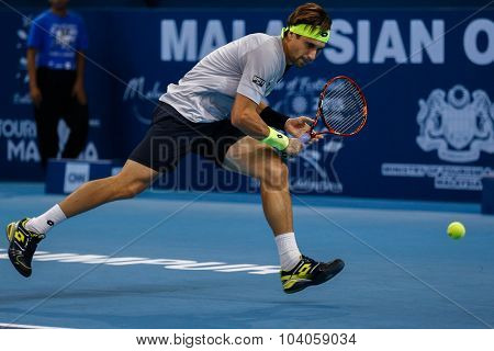 KUALA LUMPUR, MALAYSIA - OCTOBER 01, 2015: David Ferrer of Spain chases a backhand return in his match at the Malaysian Open 2015 Tennis tournament held at the Putra Stadium, Malaysia.