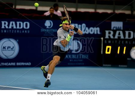 KUALA LUMPUR, MALAYSIA - OCTOBER 01, 2015: David Ferrer of Spain hits a backhand return in his match at the Malaysian Open 2015 Tennis tournament held at the Putra Stadium, Malaysia.