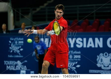 KUALA LUMPUR, MALAYSIA - OCTOBER 01, 2015: Mischa Zverev of Germany attempts a forehand return during his match at the Malaysian Open 2015 Tennis tournament held at the Putra Stadium, Malaysia.