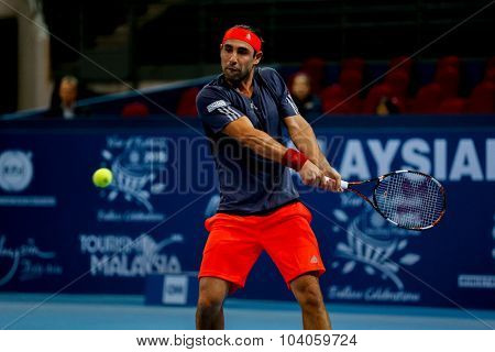 KUALA LUMPUR, MALAYSIA - OCTOBER 01, 2015: Marcos Baghdatis of Cyprus plays a backhand return during his match at the Malaysian Open 2015 Tennis tournament held at the Putra Stadium, Malaysia.