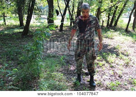 MUSKOGEE, OK - Sept. 12: An actor dressed as a zombie hides in a field and waits for the next runner during the Castle Zombie Run at the Castle of Muskogee in Muskogee, OK on September 12, 2015. 
