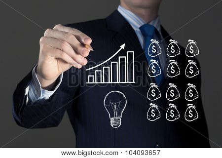 Close up of businessman drawing money making formula