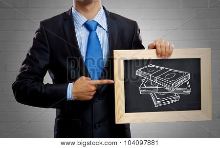 Unrecognizable businessman holding blackboard with drawn money concept