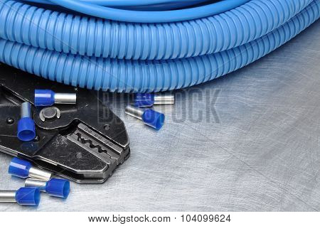 Tools for electricians crimpers and accessories on metal surface with place for text