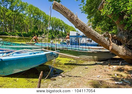 Beached Fisherman Boat, Tied To A Tree.