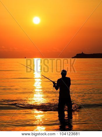 Fisherman Silhouette At Sunrise