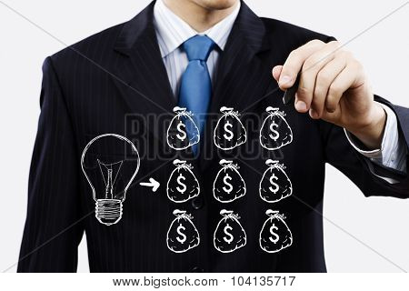 Close up of businessman drawing money making formula